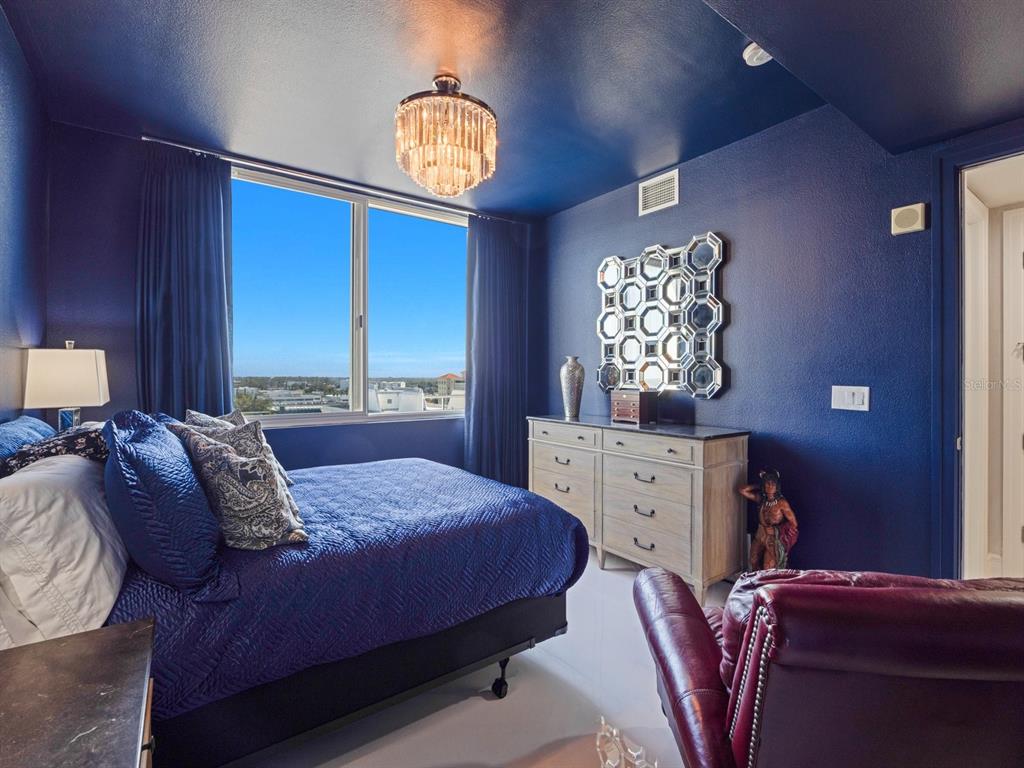 331 Cleveland Street, Unit 1101 Clearwater, FL 33755 - Photo 15 of 77 a bedroom with a bed chandelier and a window