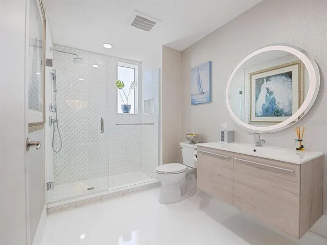 a kitchen with stainless steel appliances kitchen island granite countertop a refrigerator and a stove top oven