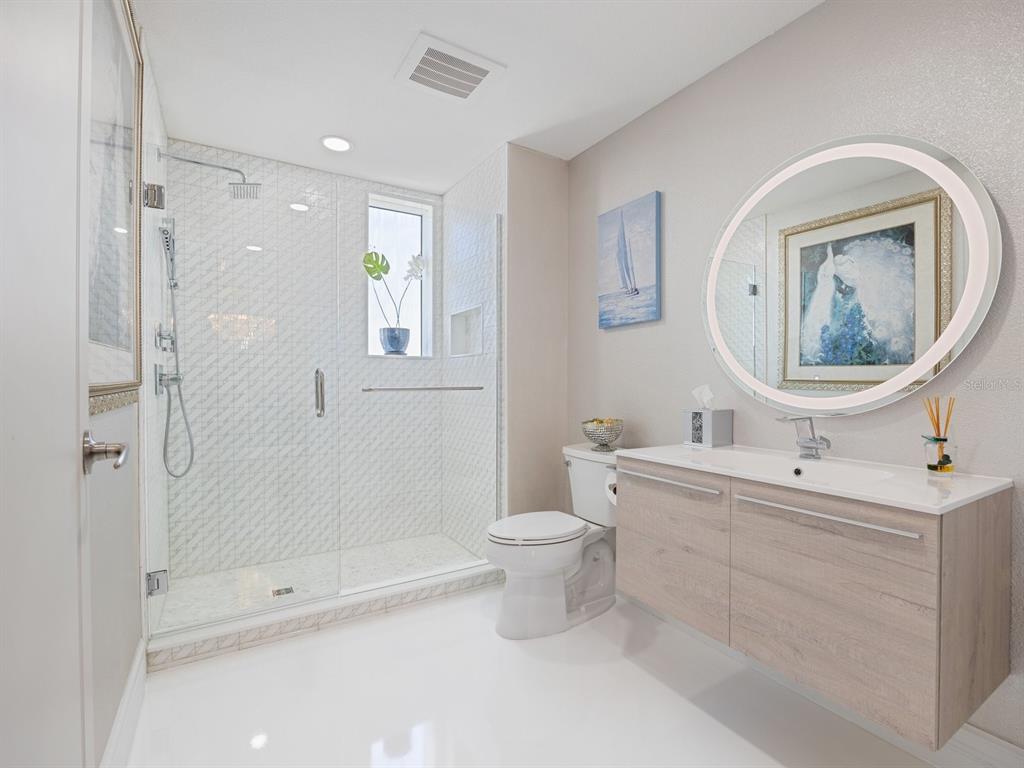 331 Cleveland Street, Unit 1101 Clearwater, FL 33755 - Photo 16 of 77 a bathroom with a toilet sink and mirror