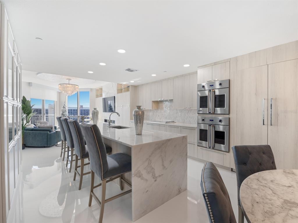 331 Cleveland Street, Unit 1101 Clearwater, FL 33755 - Photo 17 of 77 a living room with stainless steel appliances kitchen island granite countertop furniture and a kitchen view