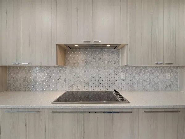 a living room with furniture potted plant and a large window