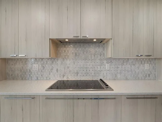 a living room with furniture potted plant and a large window