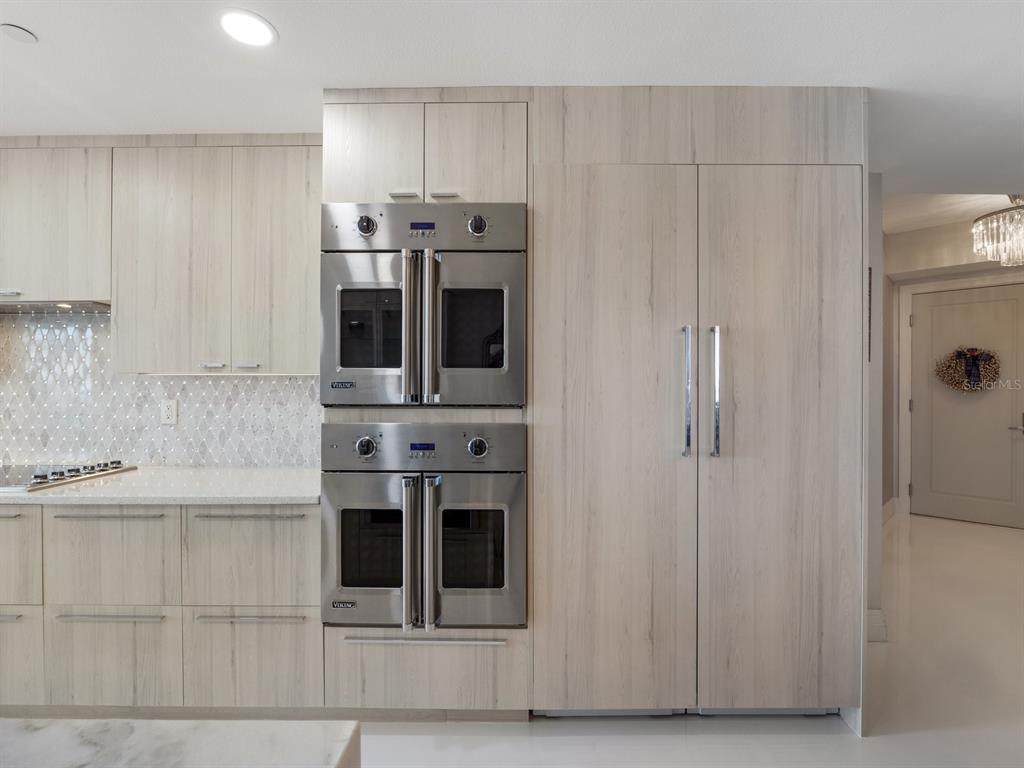 331 Cleveland Street, Unit 1101 Clearwater, FL 33755 - Photo 21 of 77 a kitchen with stainless steel appliances kitchen island granite countertop a refrigerator and a sink
