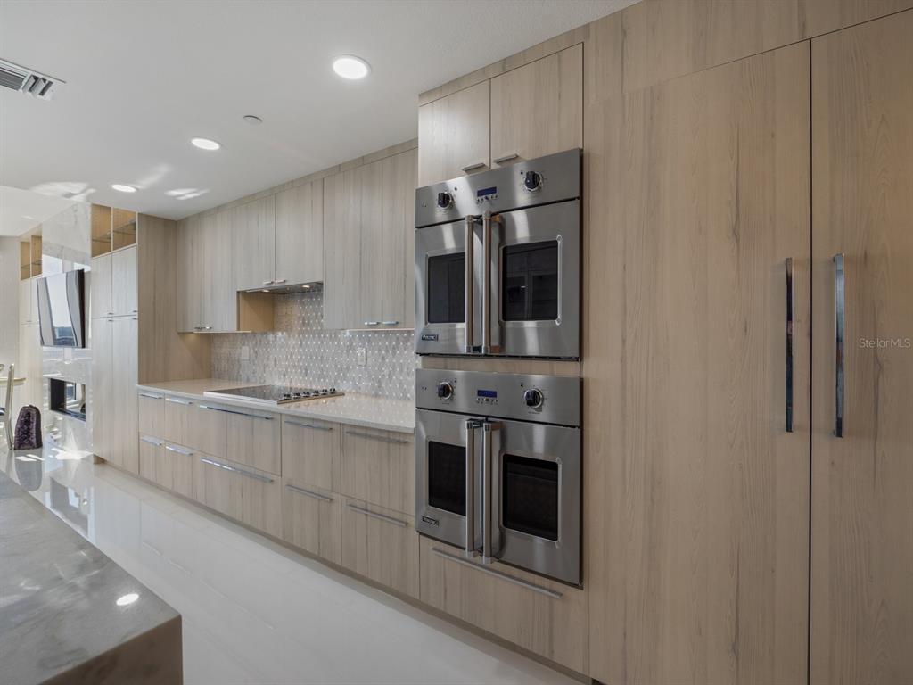 331 Cleveland Street, Unit 1101 Clearwater, FL 33755 - Photo 22 of 77 a kitchen with stainless steel appliances granite countertop a stove and a refrigerator