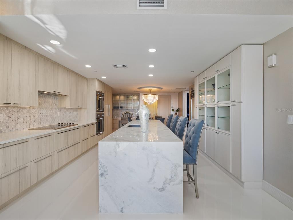 331 Cleveland Street, Unit 1101 Clearwater, FL 33755 - Photo 23 of 77 a kitchen with stainless steel appliances kitchen island granite countertop a refrigerator and a stove top oven