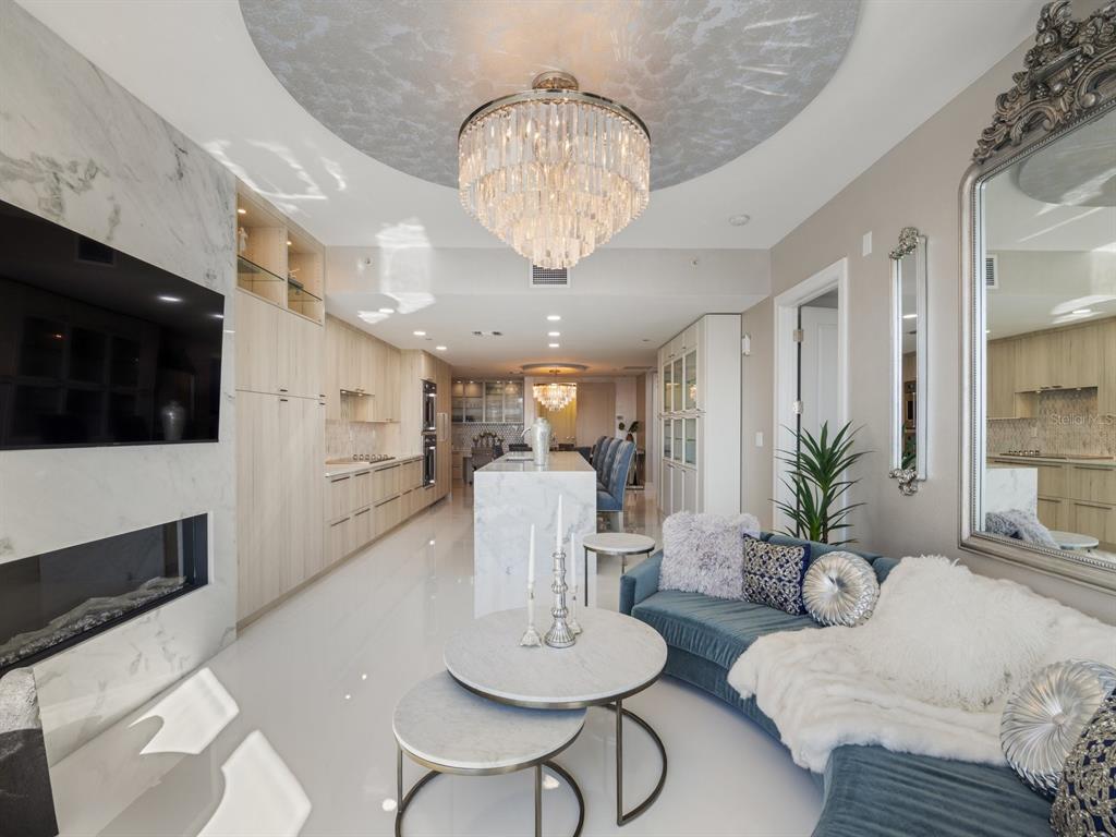 331 Cleveland Street, Unit 1101 Clearwater, FL 33755 - Photo 26 of 77 a living room with furniture a dining table and a fireplace