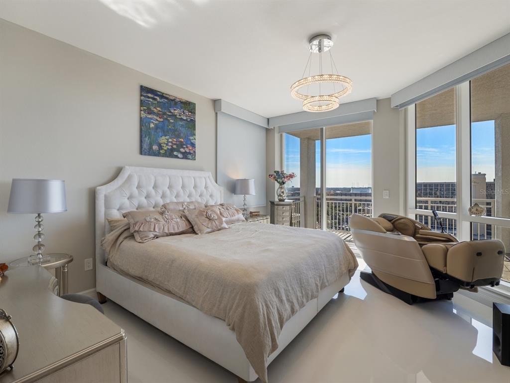 331 Cleveland Street, Unit 1101 Clearwater, FL 33755 - Photo 31 of 77 a spacious bedroom with a bed and a chandelier
