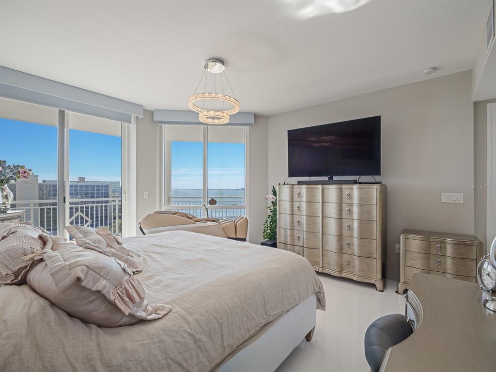 331 Cleveland Street, Unit 1101 Clearwater, FL 33755 - Photo 32 of 77 a bedroom with a bed and a television
