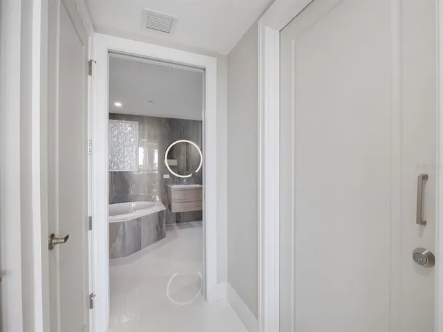 a view of a dining room with a table and chairs