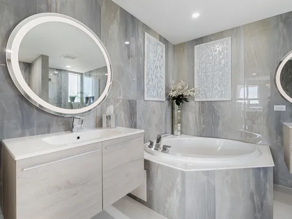 a room with furniture pool table flat screen tv and windows