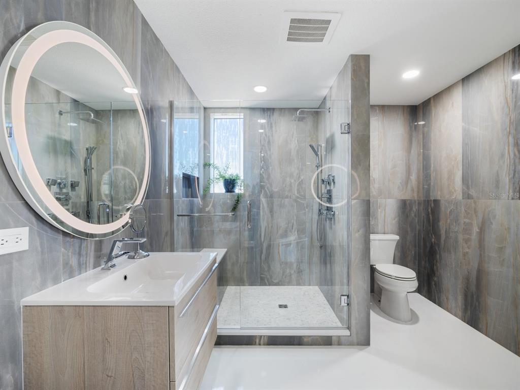 331 Cleveland Street, Unit 1101 Clearwater, FL 33755 - Photo 38 of 77 a bathroom with a sink a toilet and a mirror