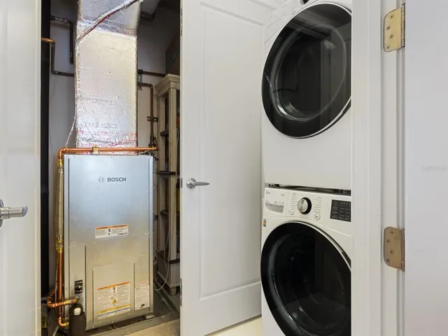 a bedroom with a bed chandelier and a window