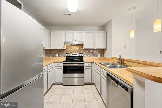 a kitchen with a sink stove and cabinets