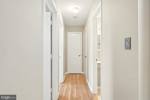 a view of hallway with wooden floor