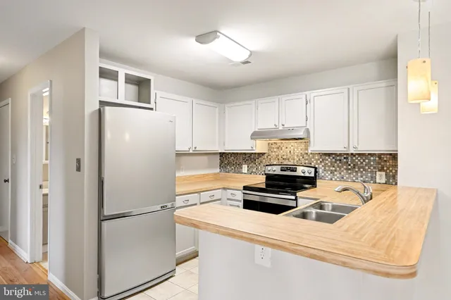 a white refrigerator freezer sitting inside of a kitchen