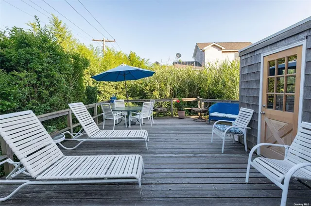 a view of a patio with table and chairs potted plants with wooden floor