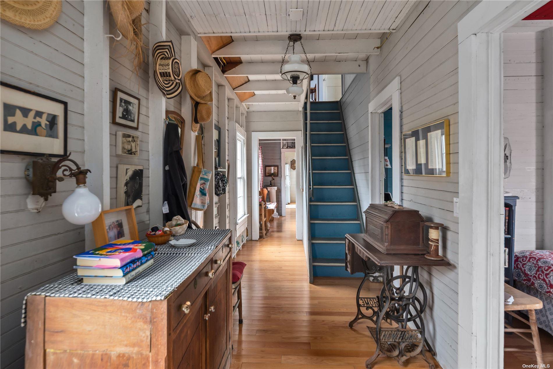 20 Ocean Road Ocean Beach, NY 11770 - Photo 2 of 19 a hallway with a couch and chandelier