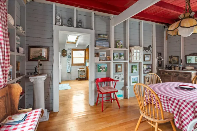 a view of a dinning room with wooden floor and outdoor seating