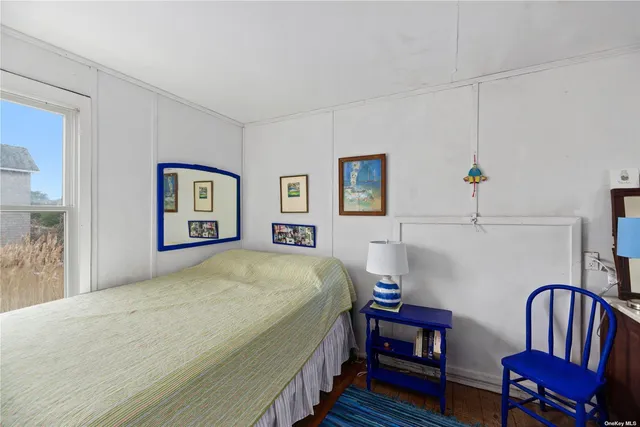 a bedroom with a bed a table and chair