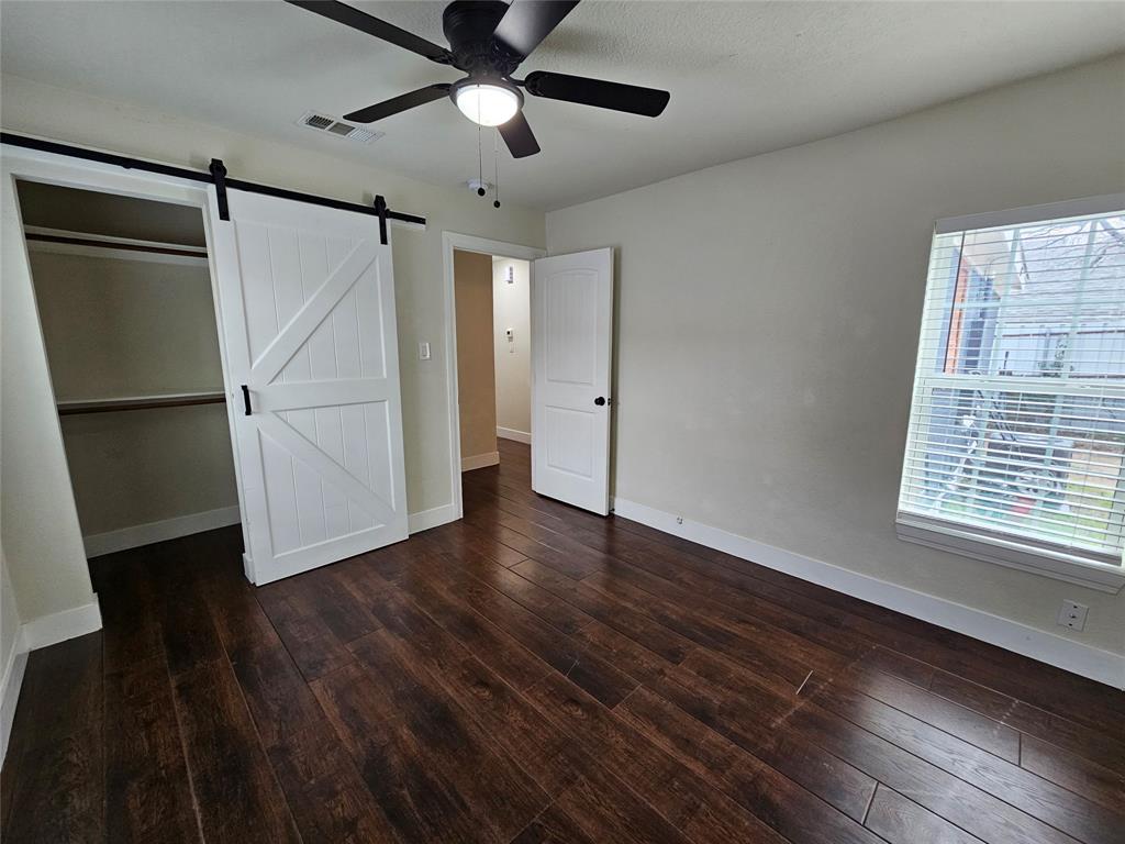 211 North Hampton Road Dallas, TX 75208 - Photo 21 of 22 Room featuring rich wood-finish flooring, a contemporary ceiling fan, and a bright window with blinds