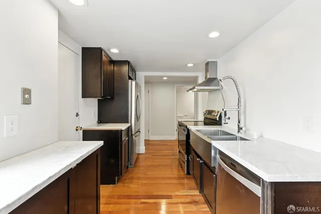 a kitchen with stainless steel appliances granite countertop a sink and stove
