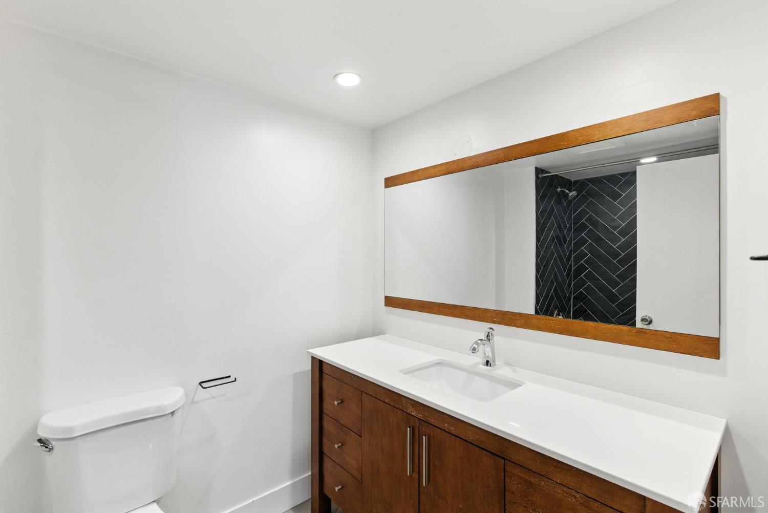 3256 16th Street, Unit 3 San Francisco, CA 94103 - Photo 10 of 16 a bathroom with a sink and a mirror