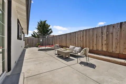 a patio with patio couch and entertaining space