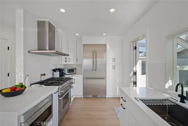 a kitchen with a stove and white cabinets