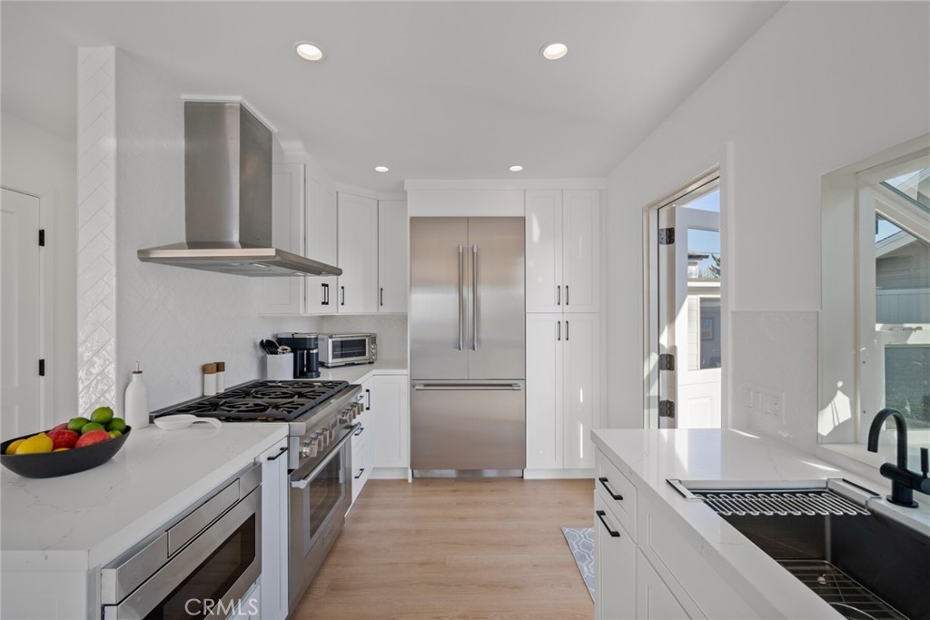 24272 Selva Road Dana Point, CA 92629 - Photo 12 of 59 a kitchen with stainless steel appliances granite countertop a sink stove and refrigerator