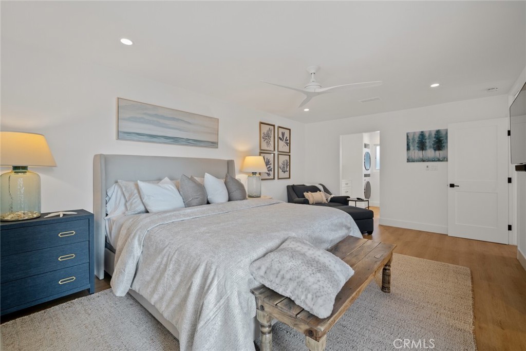 24272 Selva Road Dana Point, CA 92629 - Photo 17 of 59 a spacious bedroom with a bed and a lamp