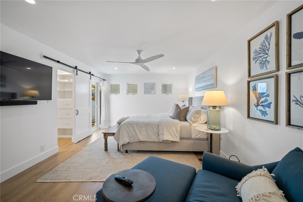 24272 Selva Road Dana Point, CA 92629 - Photo 18 of 59 a spacious bedroom with a bed and a flat screen tv