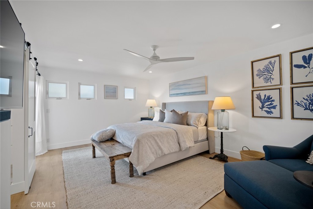 24272 Selva Road Dana Point, CA 92629 - Photo 19 of 59 a spacious bedroom with a bed and window