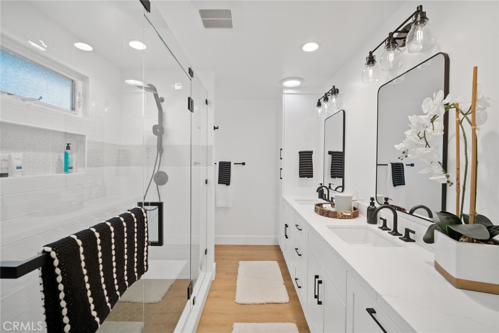 24272 Selva Road Dana Point, CA 92629 - Photo 20 of 59 a large white bathroom with a double vanity sink a mirror and a shower