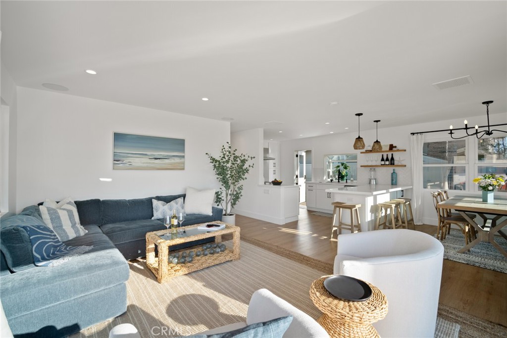 24272 Selva Road Dana Point, CA 92629 - Photo 2 of 59 a living room with furniture and a dining table with wooden floor
