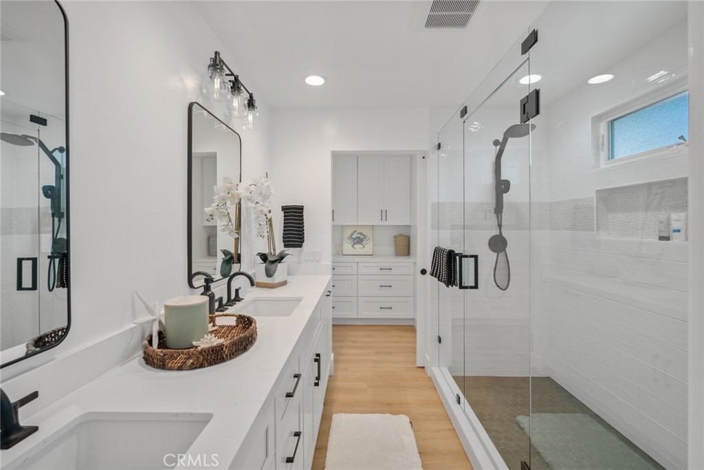 24272 Selva Road Dana Point, CA 92629 - Photo 21 of 59 a bathroom with double vanity sink and a mirror