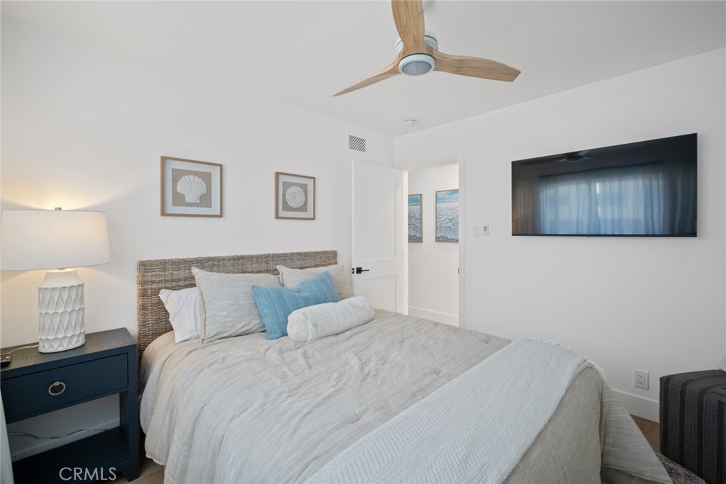 24272 Selva Road Dana Point, CA 92629 - Photo 23 of 59 a bedroom with a bed and a chandelier