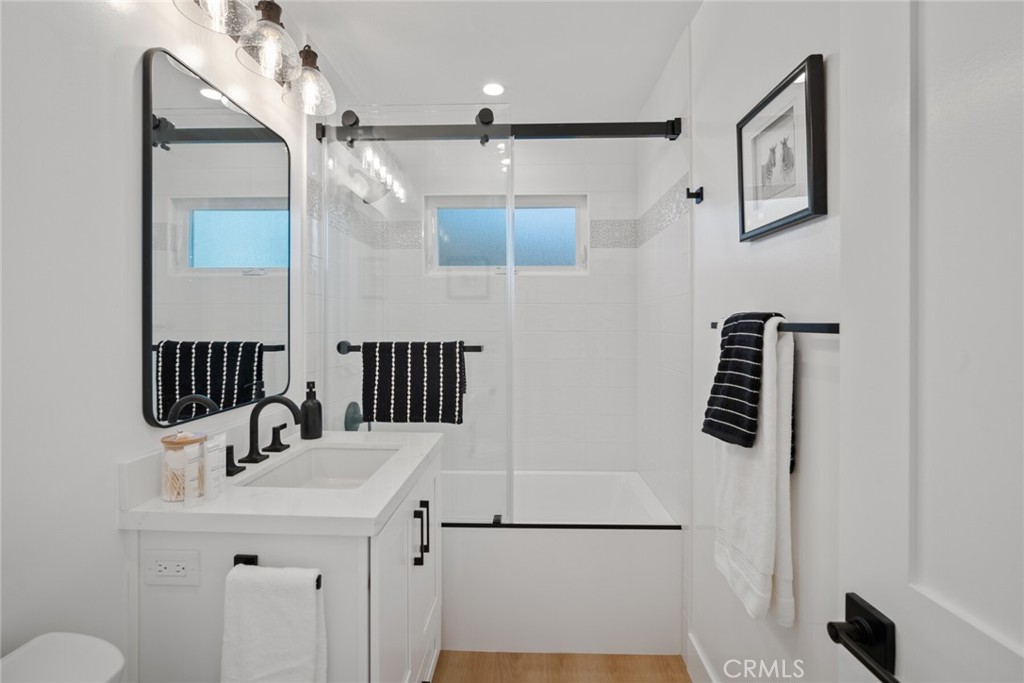 24272 Selva Road Dana Point, CA 92629 - Photo 25 of 59 a bathroom with a sink a mirror and shower