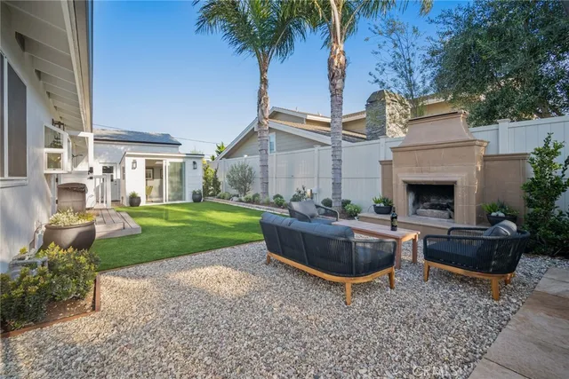 a view of a house with backyard and sitting area