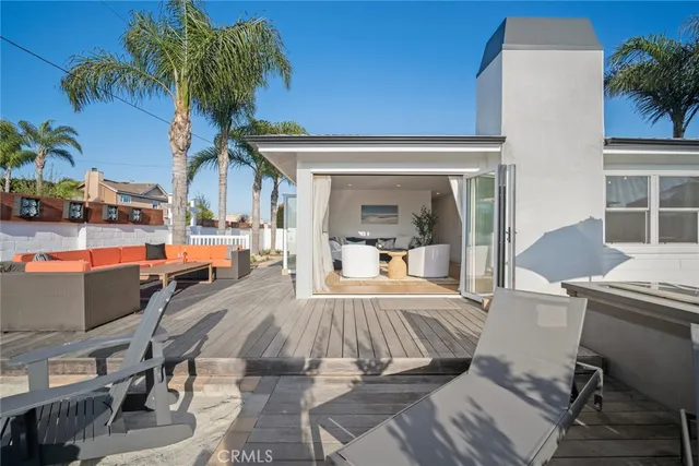 a view of a patio with couches table and chairs and potted plants