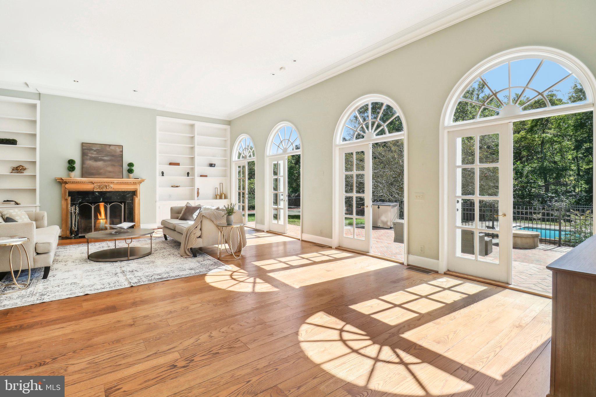 10650 Gunston Road Lorton, VA 22079 - Photo 15 of 73 a living room with furniture a fireplace and a floor to ceiling window