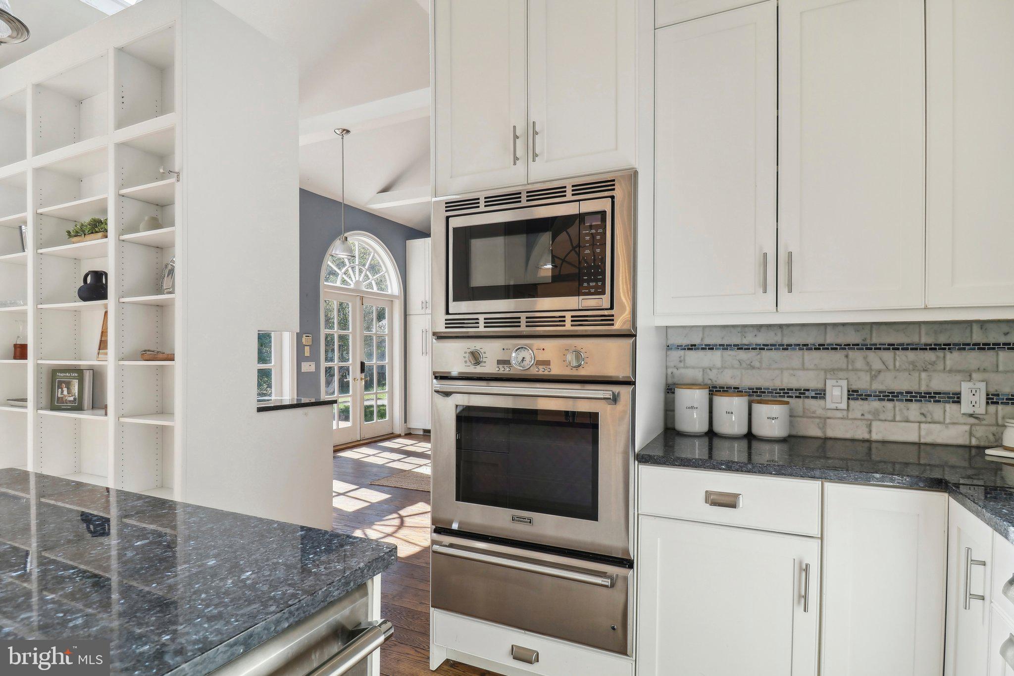 10650 Gunston Road Lorton, VA 22079 - Photo 26 of 73 a kitchen with granite countertop a stove and a microwave