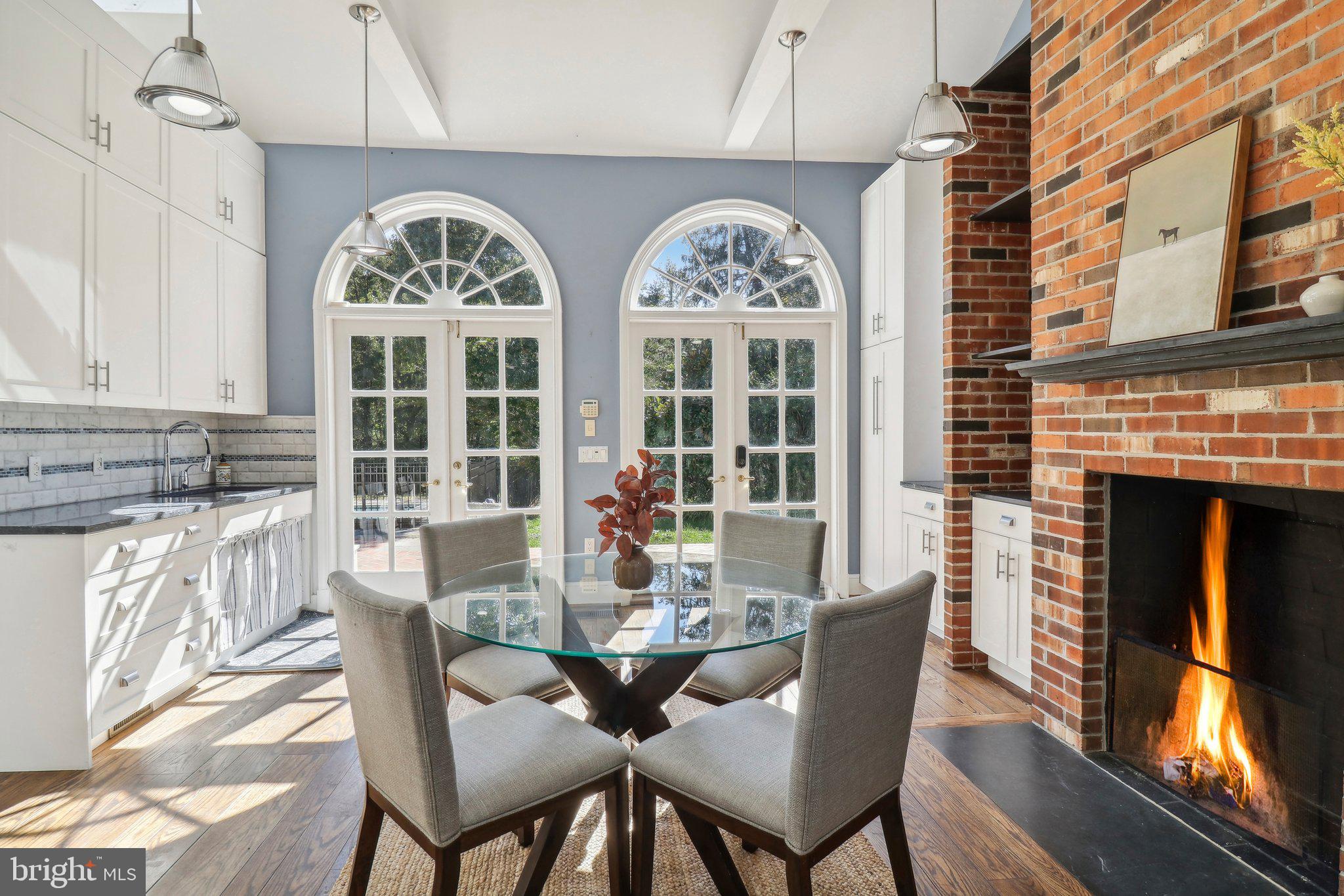 10650 Gunston Road Lorton, VA 22079 - Photo 30 of 73 a dining room with furniture a fireplace and wooden floor