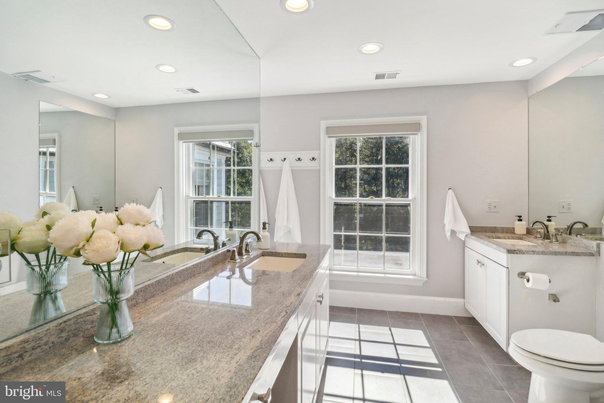 10650 Gunston Road Lorton, VA 22079 - Photo 39 of 73 a bathroom with a granite countertop sink a toilet and bathtub