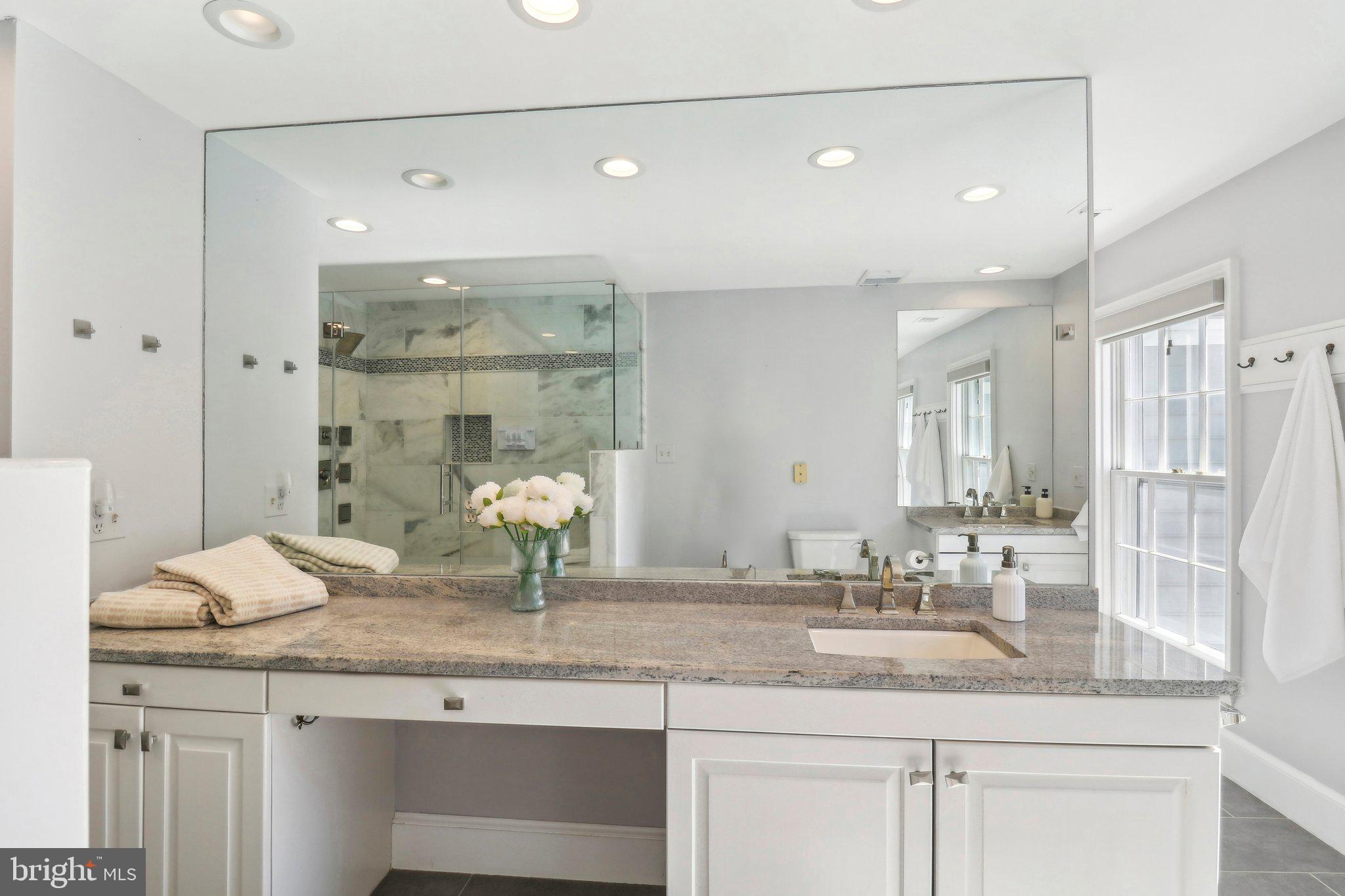 10650 Gunston Road Lorton, VA 22079 - Photo 42 of 73 a bathroom with a granite countertop double vanity sink and mirror