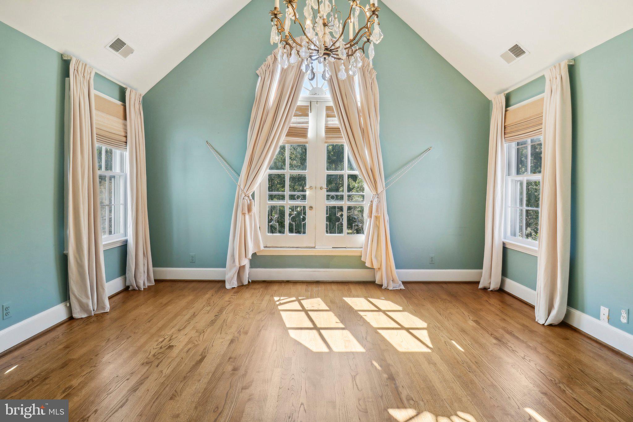 10650 Gunston Road Lorton, VA 22079 - Photo 45 of 73 an empty room with wooden floor a fireplace and windows