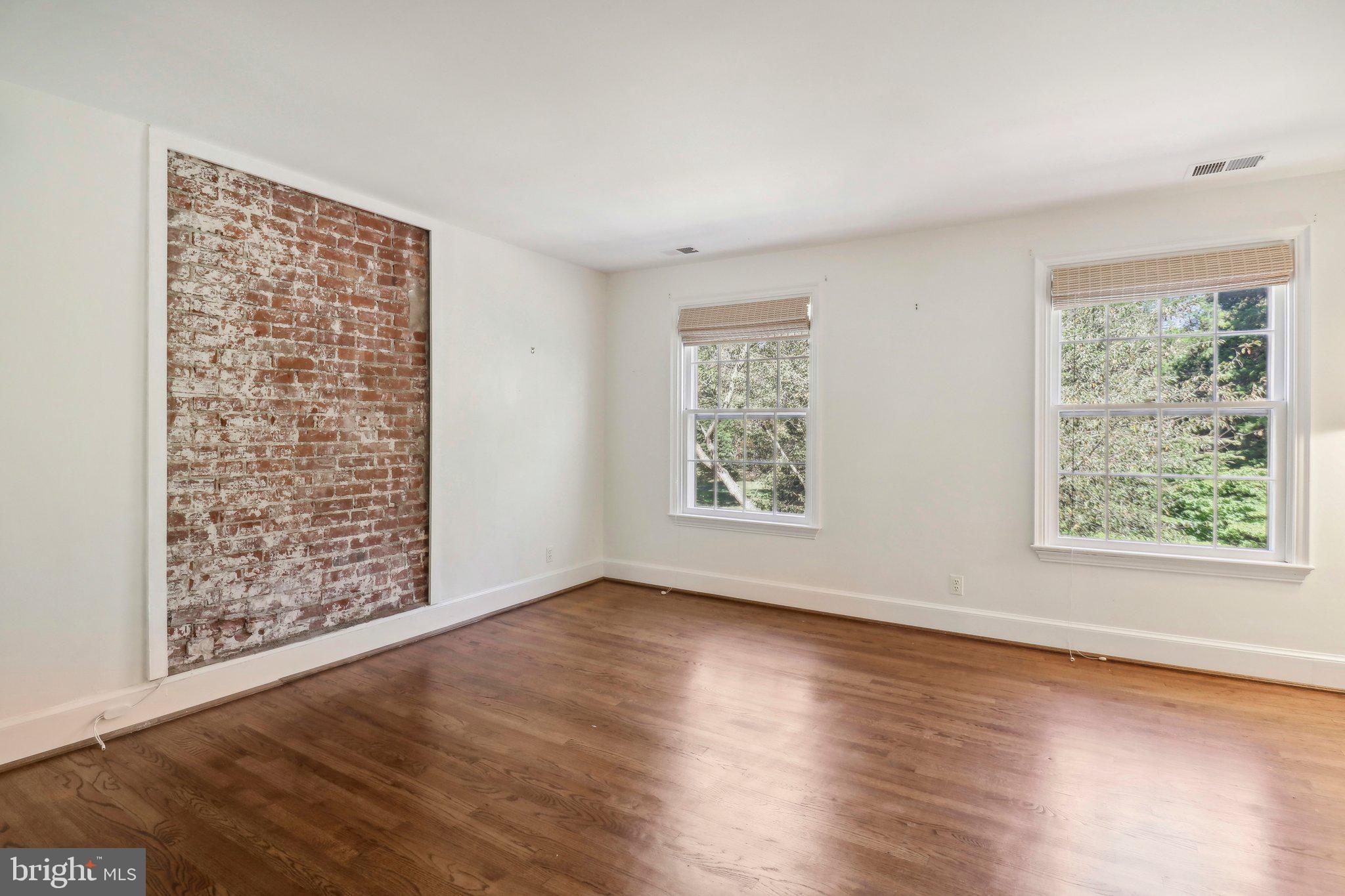 10650 Gunston Road Lorton, VA 22079 - Photo 50 of 73 a view of an empty room with wooden floor and a window