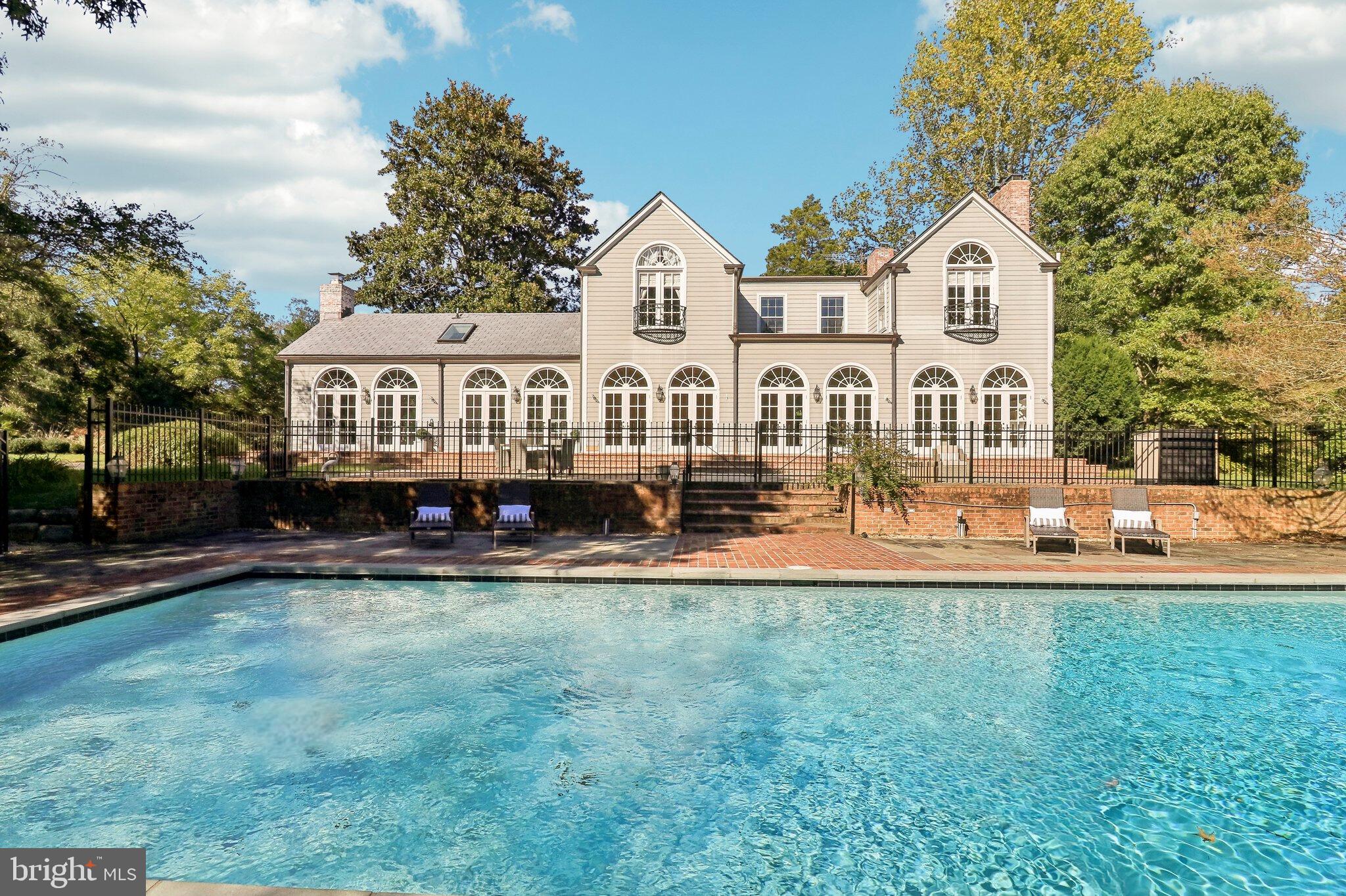 10650 Gunston Road Lorton, VA 22079 - Photo 59 of 73 a front view of a house with a yard and trees