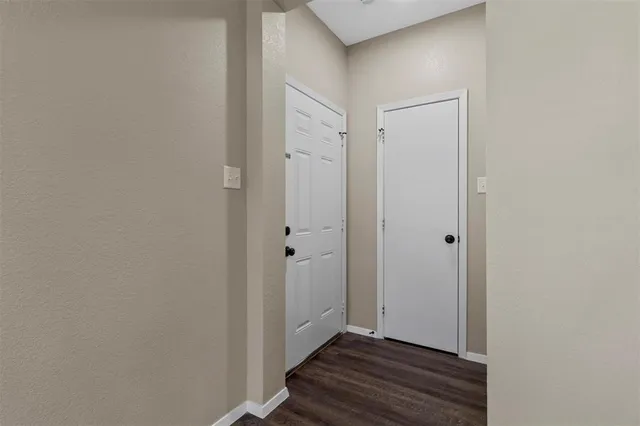 a view of an entryway with wooden floor