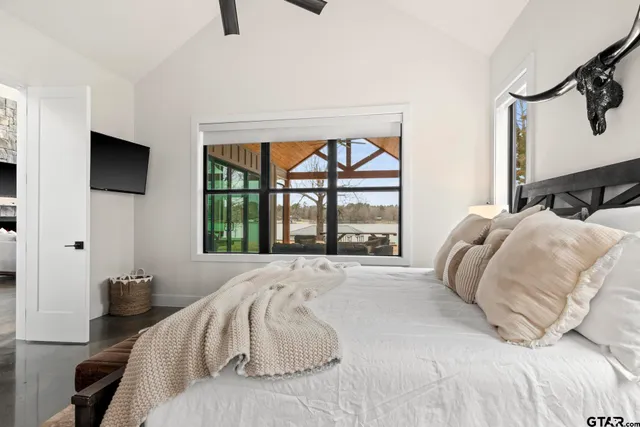 a bed sitting in a bedroom next to a window