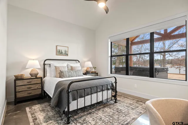 a bedroom with a large bed and a large window